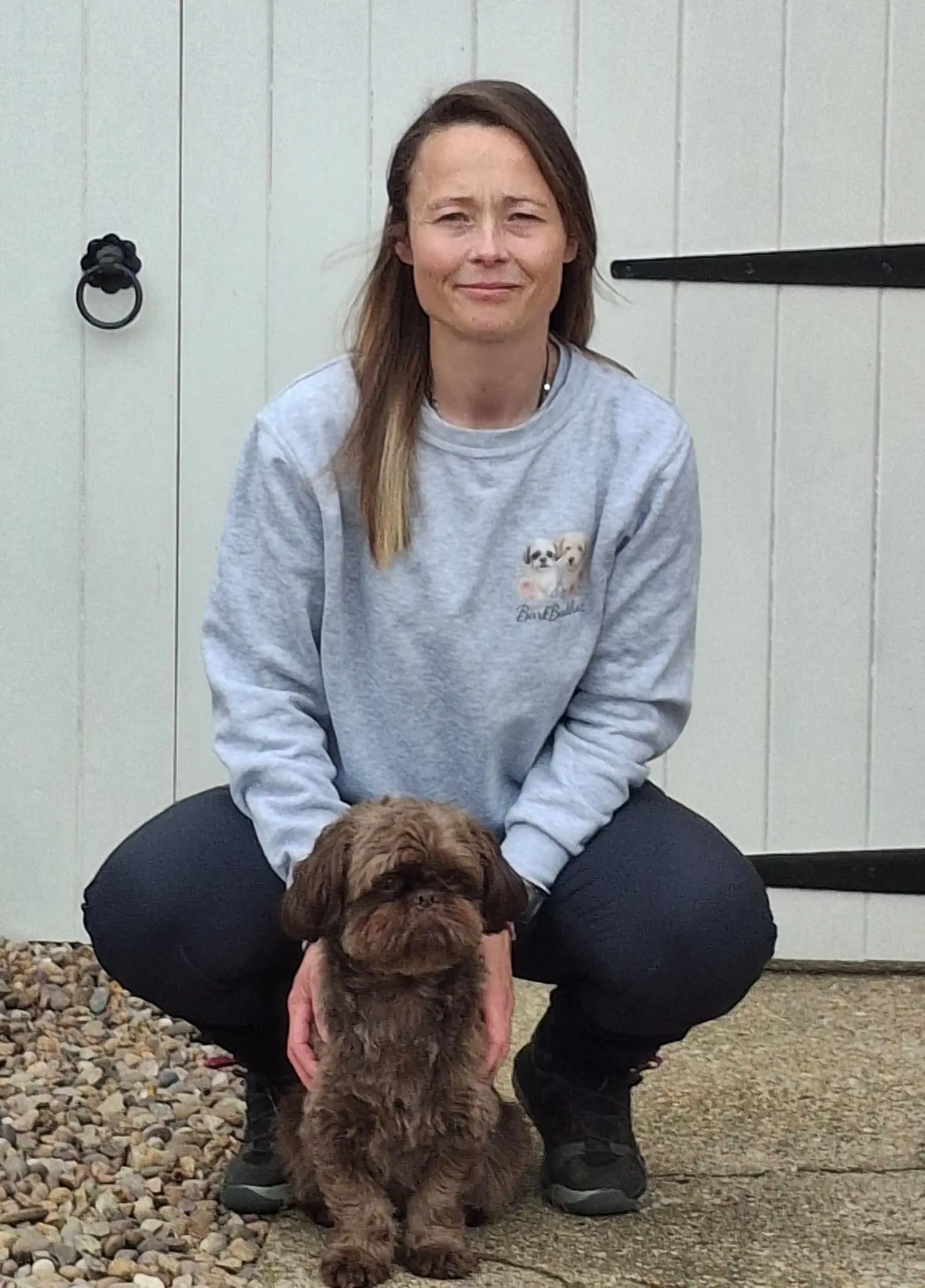 Cat, owner and founder of BarkBuddiez, with Pickle outside the salon